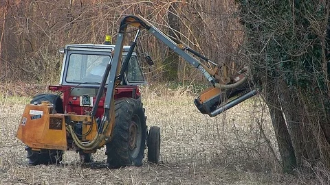 Agricultural labor.  Tractor with shredder to work the field border . Stock Footage 73578442