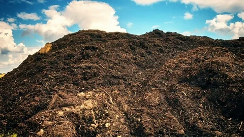 Agricultural landscape with composted soil pile (organic fertilizer) Stock Footage 70384997