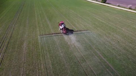 Agricultural machine, tractor working in field. Sprays toxic chemicals Stock Footage 278281936
