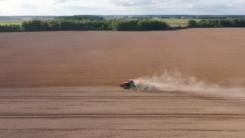 Agricultural machinery performs precise planting of crops in plowed field Video stock 311050295
