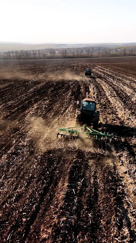 Agricultural machinery plowing a field in sequential frames, showcasing the Stock Footage 338398585