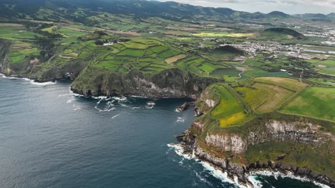 Agricultural patchwork landscape above rocky shore with Atlantic Ocean Stock-Footage 334970185