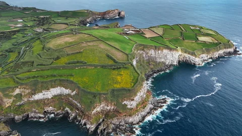 Agricultural patchwork landscape along rocky Atlantic shore in Azores Stock Footage 329001878