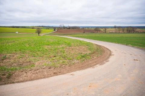  Agricultural path between multiple agricultural fields during cloudy day,... Stock Photos
