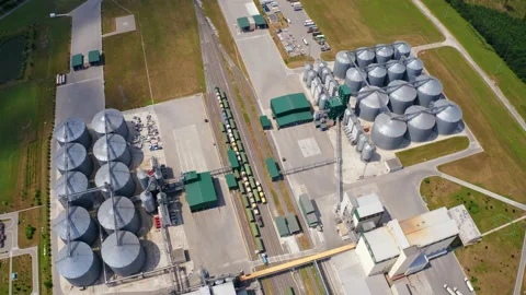 Agricultural silos on field. Grain elevators for storage and drying of cereals.  Stock Footage 158833644