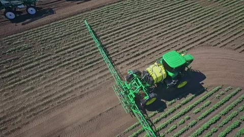 Agricultural sprayer irrigating on farming field. Fertilizer spreader Stock Footage