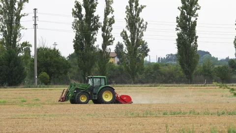 Agricultural tractor performs cultivation work with mechanized tools. Italy Stock Footage 161770352