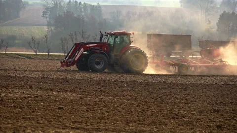 Agricultural tractor performs cultivation work with mechanized tools. Stock Footage 197487026