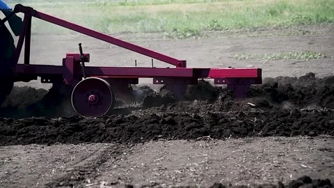 Agricultural tractor plowing a field Vídeos de archivo 216897737