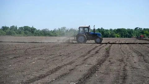 Agricultural tractor plowing a field Stock Footage 220445513