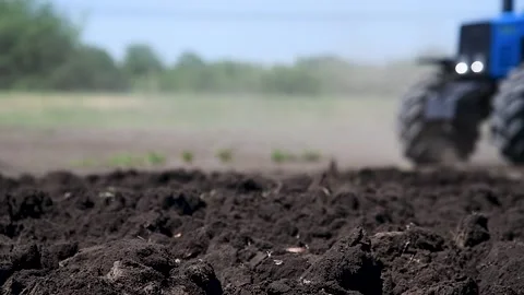 Agricultural tractor plowing a field Stock Footage 220445546