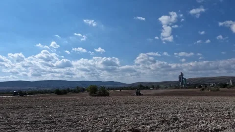 Agricultural tractor plowing soil on a large field Stock Footage 345927018