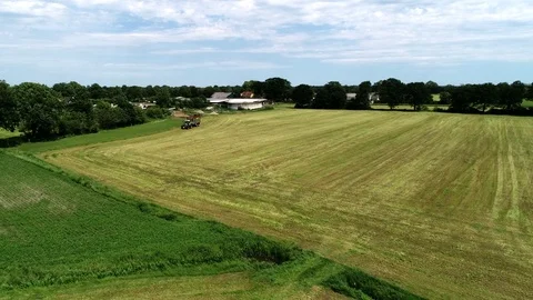Agricultural tractor returns grass for the haymaking Stock Footage 117621287