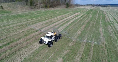 Agricultural tractor spraying of fields Stock Footage 91174014