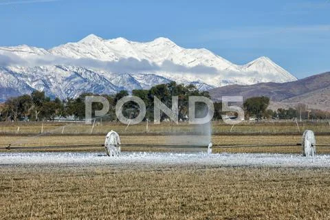 Agriculture Farm Irrigation Sprinkler System Frozen Ice Mountain Valley .