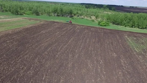 Agriculture machine spread fertilizer on cultivated field soil in summer Stock Footage