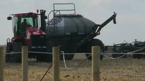 Agriculture, tractor and seeder planting canola, spring, turn, #2 Stock Footage