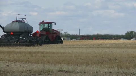 Agriculture, tractor and seeder planting canola, spring through frame, #5 Stock Footage