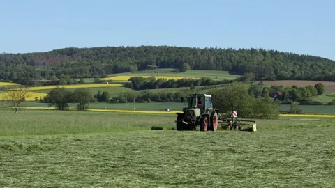 Agriculture with tractor of a meadow Stock Footage 154643229