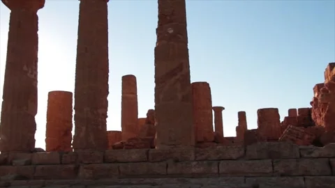 Agrigento sicily italy ancient temple of juno with sun behind tilt and pan Stock Footage 252154158