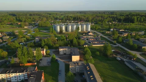 Agro-industrial complex in small township with apartment buildings, aerial Stock Footage 242159272