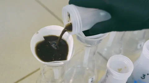 Agrochemical Analyst pouring Soil Samples Mixed with Extracts into Lab Filters Stock Footage 248058684