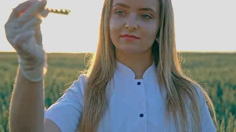 Agronomist or a student with document in hand writes results of her experiment Stockbeeldmateriaal 92926440