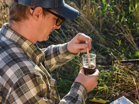 Agronomy specialist testing soil sample labortory equipment outdoors Stock Photos