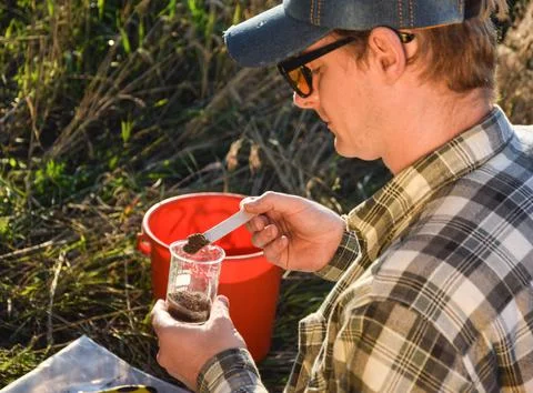 Agronomy specialist testing soil sample labortory equipment outdoors Stock Photos