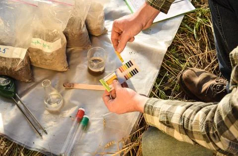 Agronomy specialist testing soil sample labortory equipment outdoors Stock Photos