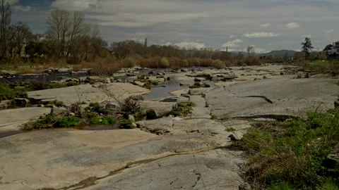 Agueda river flowing low through an exposed rocky riverbed near Puente del .. Stock Footage 335462181