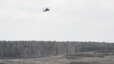 The AH-64 Apache is an American twin-turboshaft attack helicopter 027 Stock Footage 166439036