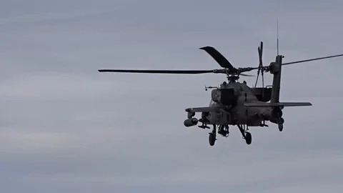 AH-64 Apache helicopter firing rocket Stock Footage 87554095