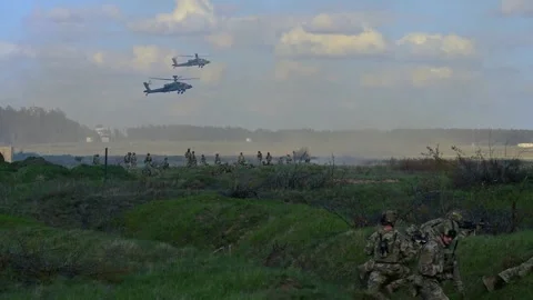 AH-64 Apache helicopters hovering near soldiers during live fire excercise Stock Footage 273293894