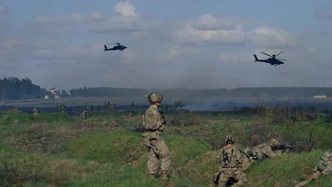 AH-64 Apache helicopters provide cover for soldiers during live fire excercise Stock Footage 273293908