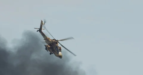 AH-64D Apache Longbow military helicopter attacking targets with canon Stock Footage 100472628