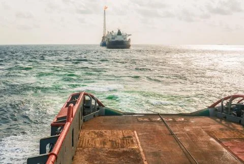 AHTS vessel doing static tow tanker lifting. Ocean tug job Stock Photos