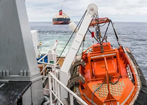 AHTS vessel doing static tow tanker lifting. Ocean tug job Stock Photos
