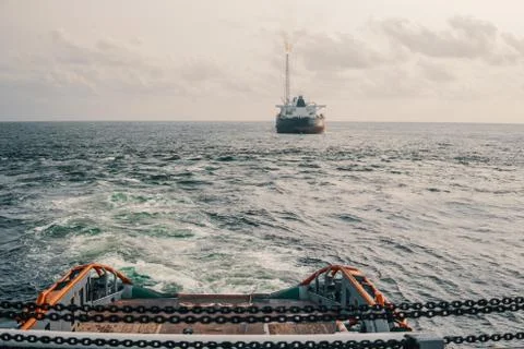 AHTS vessel doing static tow tanker lifting. Ocean tug job Stock Photos