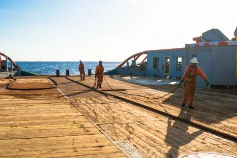 AHTS vessel doing static tow tanker lifting. Ocean tug job Stock Photos