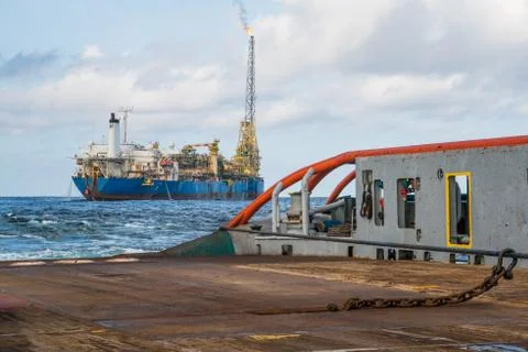 AHTS vessel doing static tow tanker lifting. Ocean tug job Stock Photos