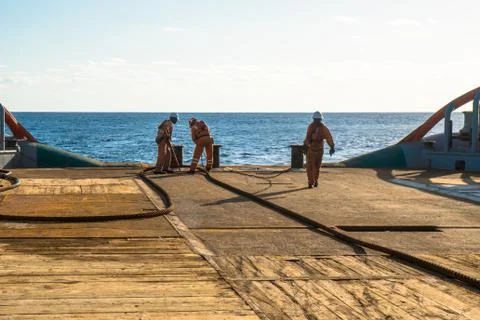 AHTS vessel doing static tow tanker lifting. Ocean tug job Stock Photos