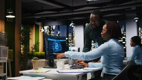 AI assistant displayed on a computer desktop helping black team complete tasks 写真素材