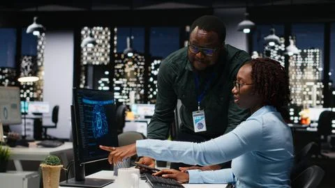 AI assistant displayed on a computer desktop helping black team complete tasks Stock Photos