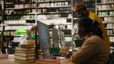 AI brain display filling desktop monitor in library study workspace Stock Footage 337229034