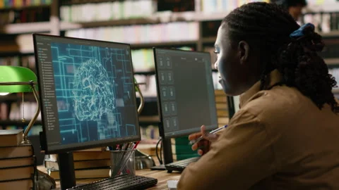 AI brain display filling desktop monitor in library study workspace Stock Footage 337231364