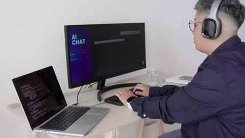 AI chatbot: Programmer using artificial intelligence for software development Stock Footage 243012943