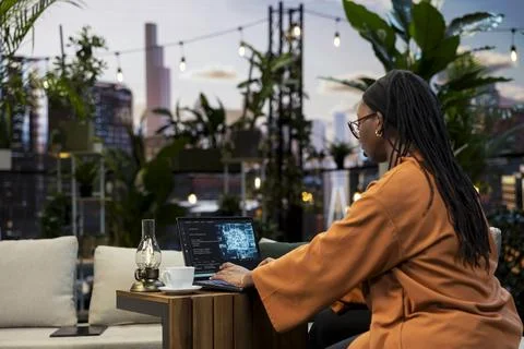 AI code and digital graphic fill laptop as woman types from rooftop Stock Photos