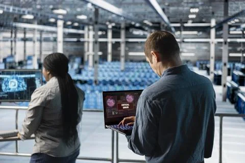 AI data center technicians detecting intrusion, trying to salvage networks Stock Photos