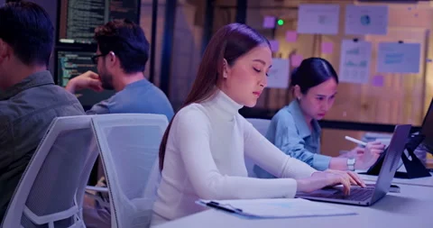 AI development team coding late night in modern office tech workspace Vídeo Stock 310483663